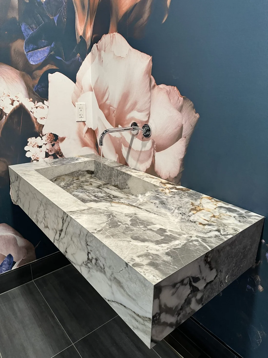 Floating marble vanity with designer wallpaper