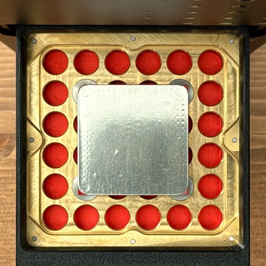 Stencil sheet attached to a 53 × 53 mm PCB blank