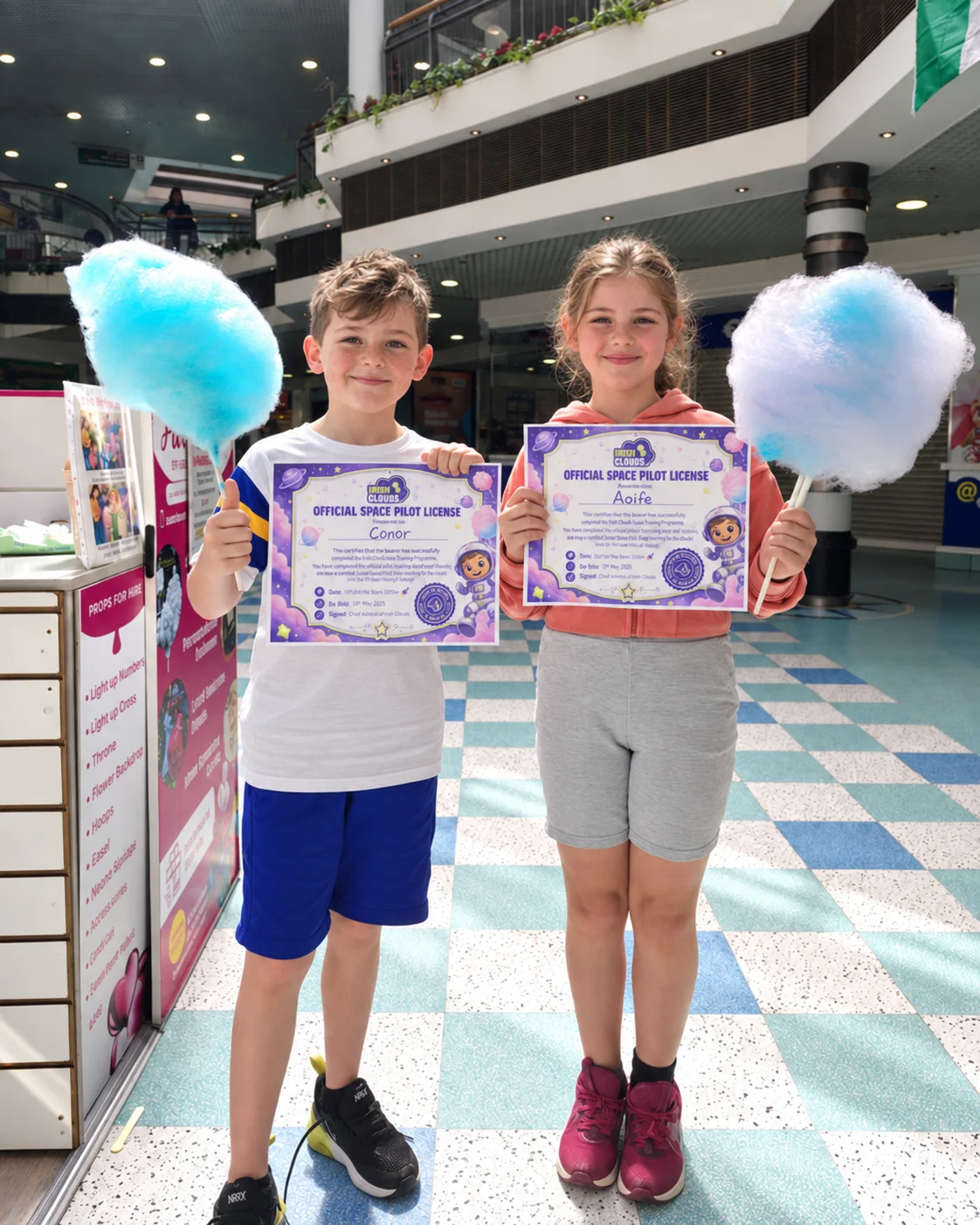 Children with candy floss and certificates