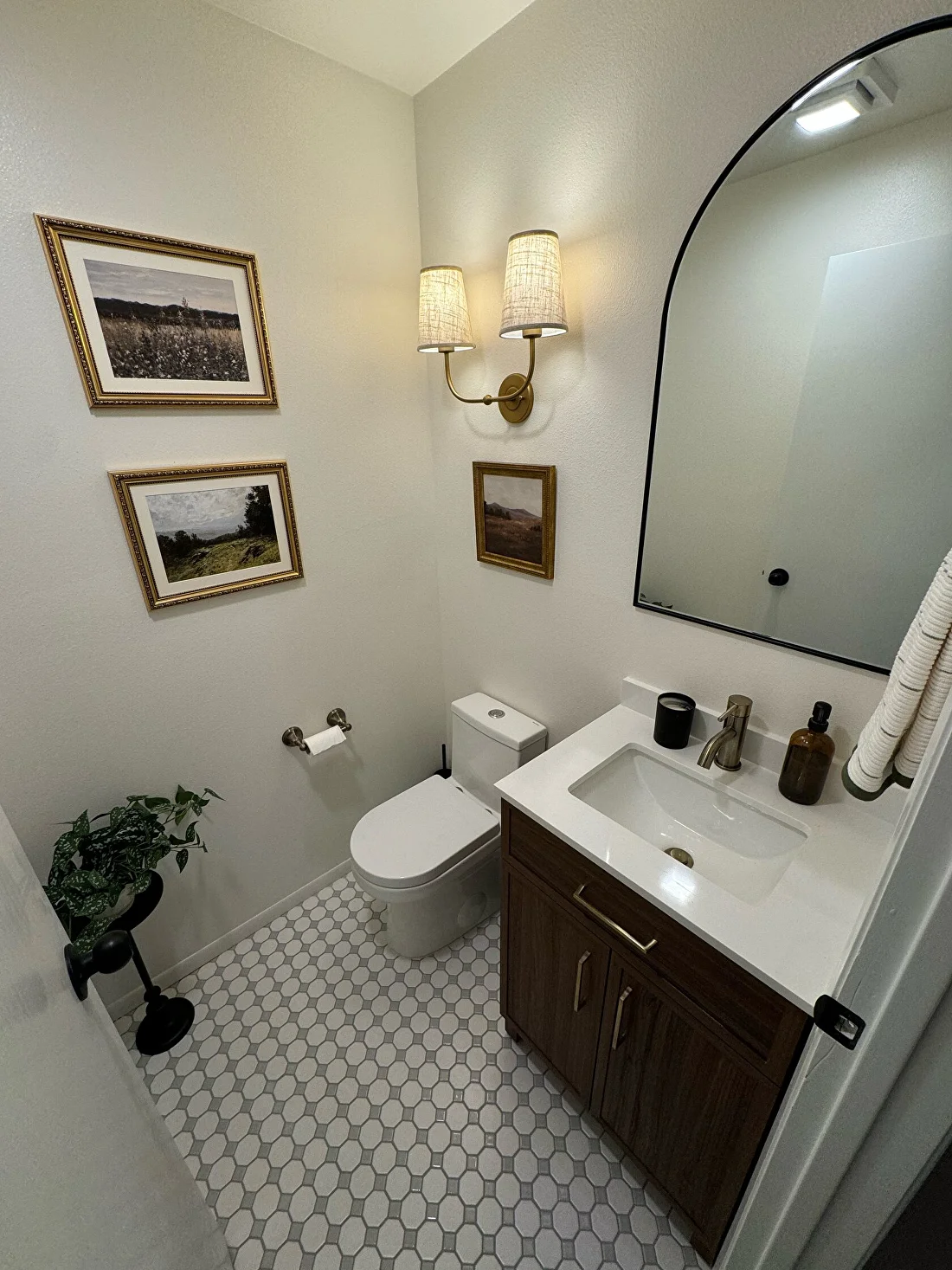 Guest bathroom with custom lighting and patterned floor