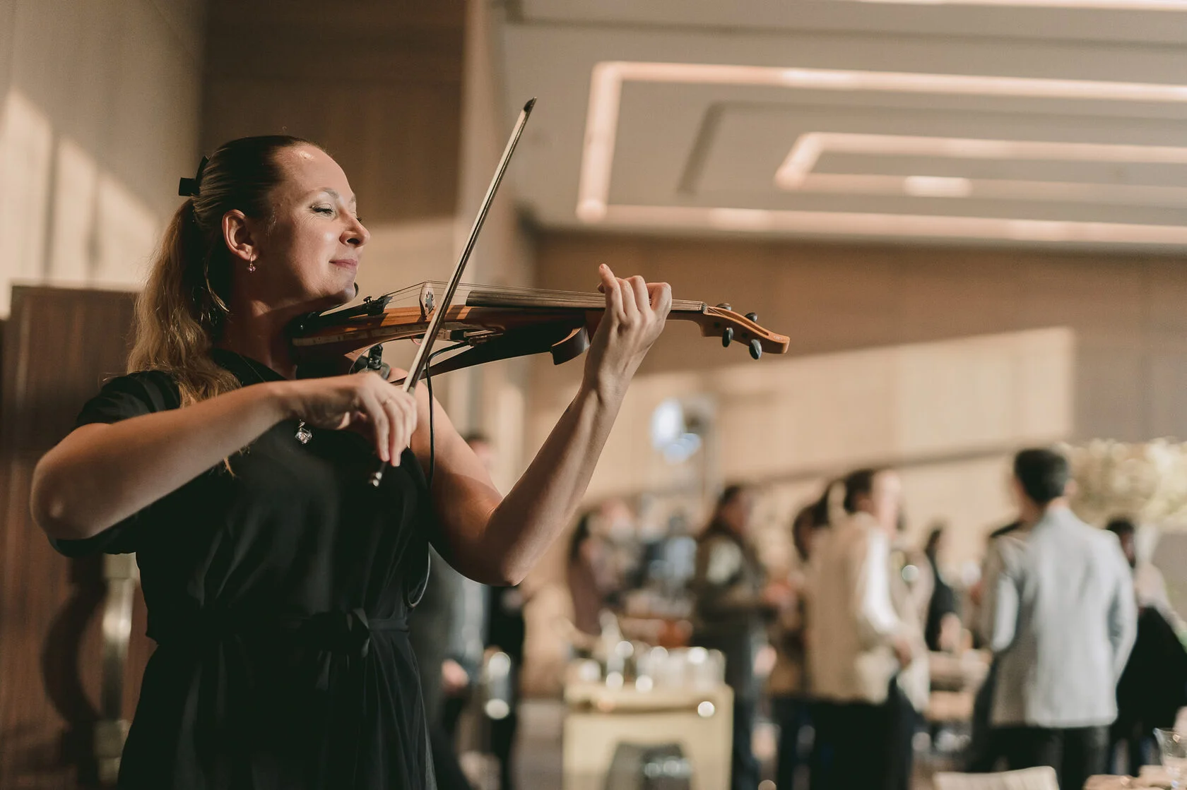 Polina performing violin at a corporate brand experience