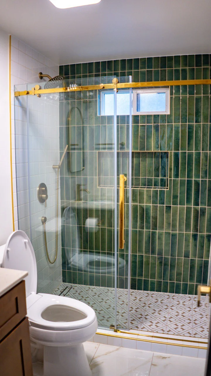 Green zellige tile shower with brass details