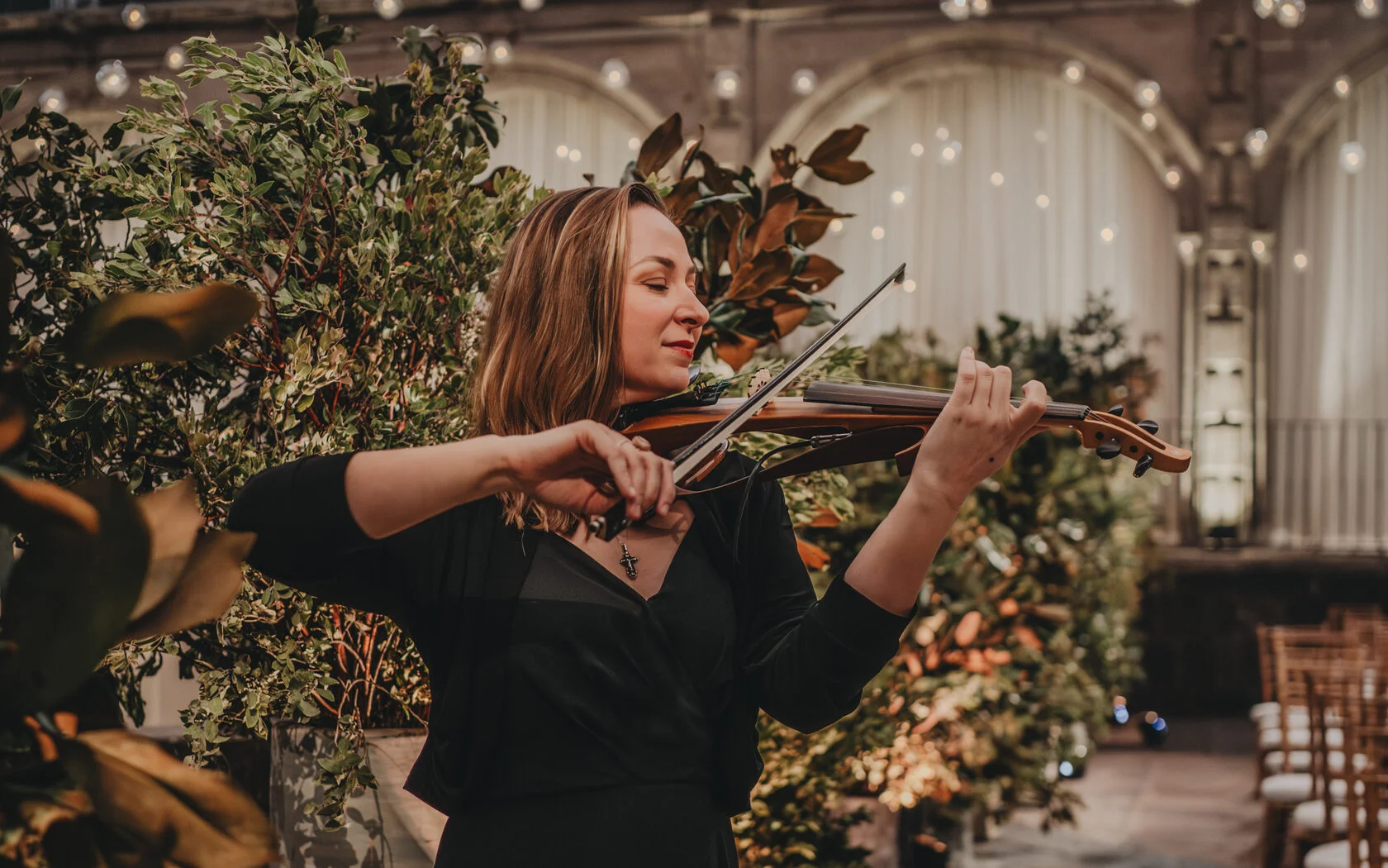 Polina performing live violin at an event in Mexico