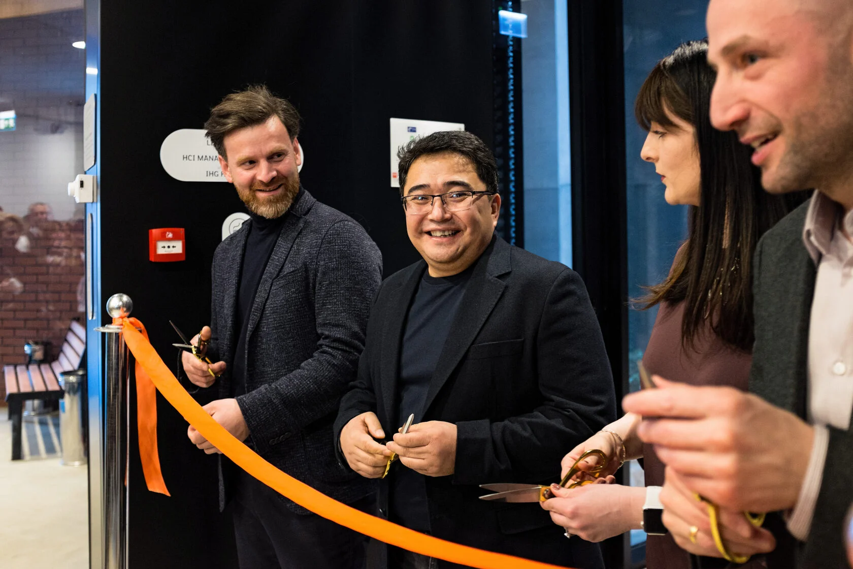 A ribbon being cut at a corporate opening