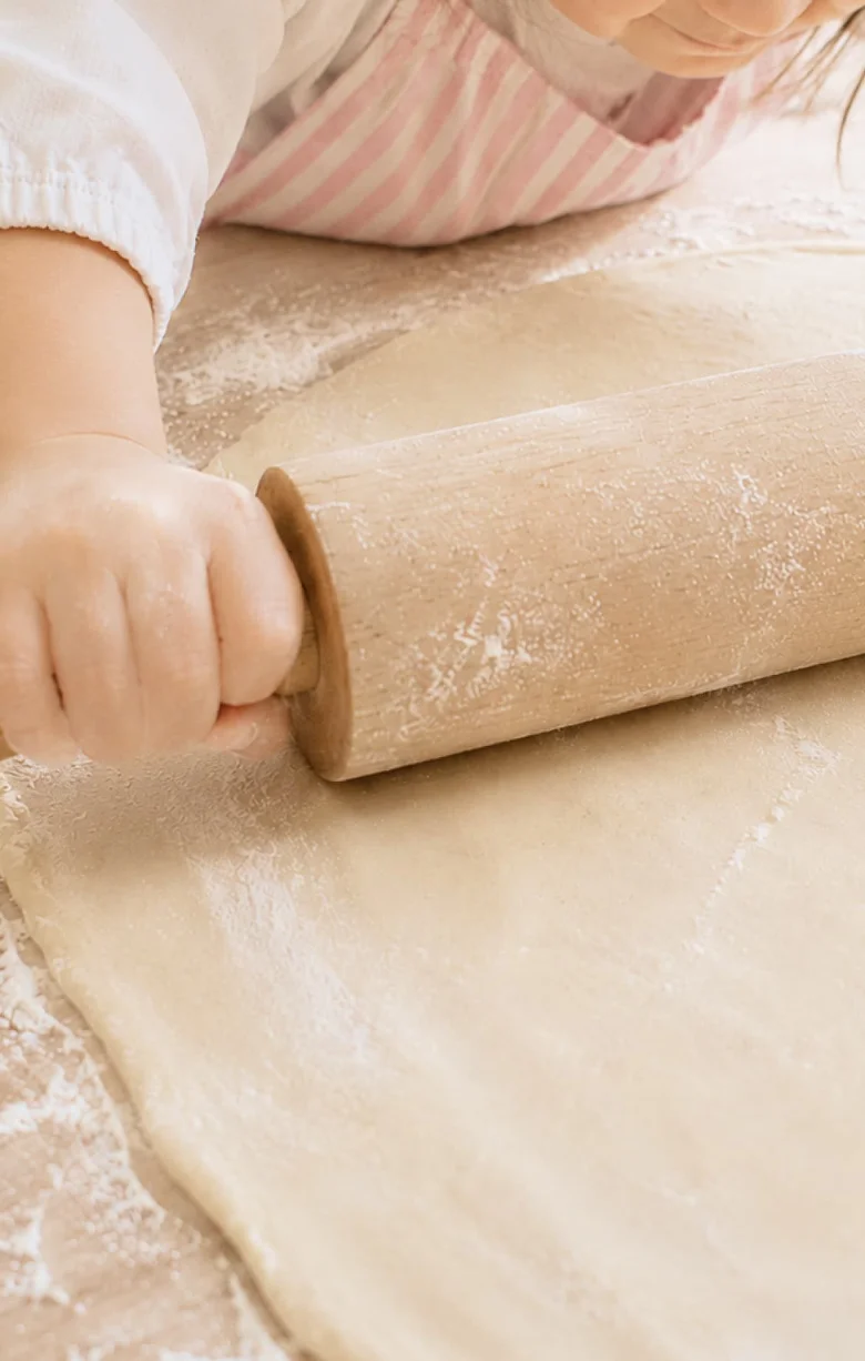 Child rolling out dough