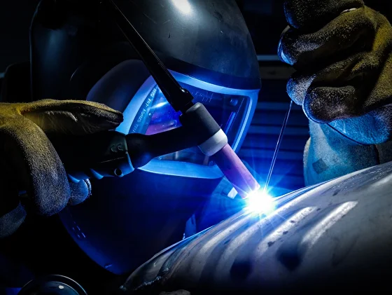 Industrial technician inspecting a welded component