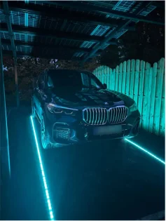 Pilot canopy at night with LED lighting and an EV parked underneath
